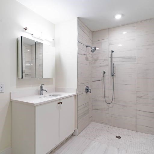 197 Green Street, Unit 202 Boston, MA 02130 - Photo 8 of 8 a bathroom with a shower sink and mirror