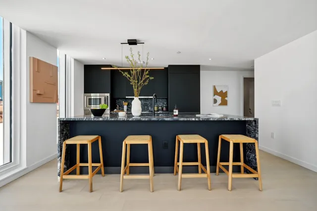 a front view of a room with wooden floor and window
