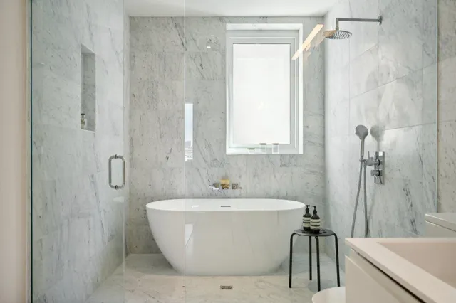 a white bath tub sitting next to a white sink