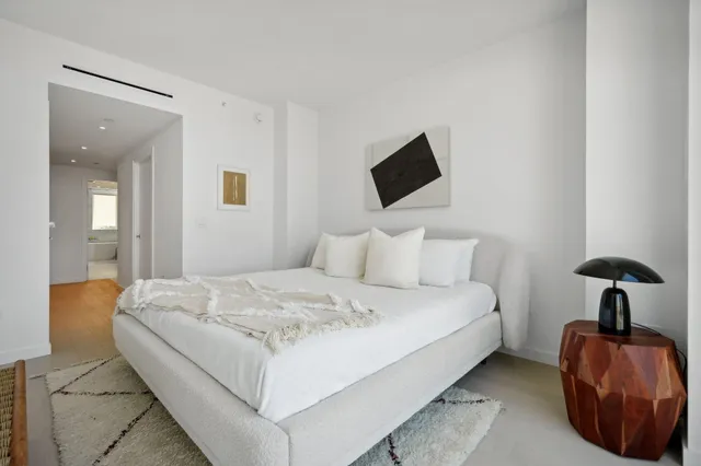 a bedroom with a bed and a chair