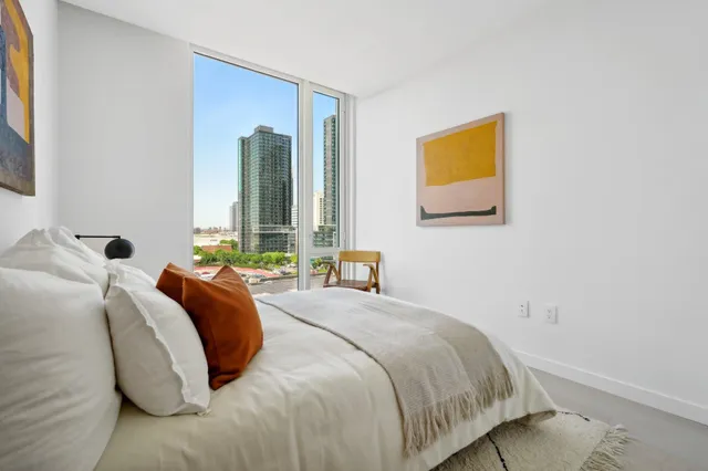 a bedroom with a bed and a painting on the wall