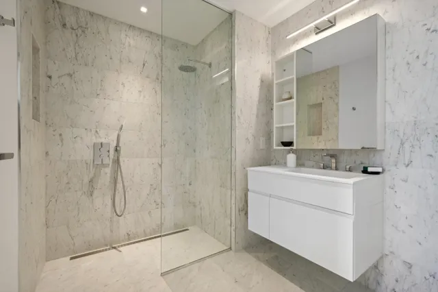 a bathroom with a sink a toilet and shower