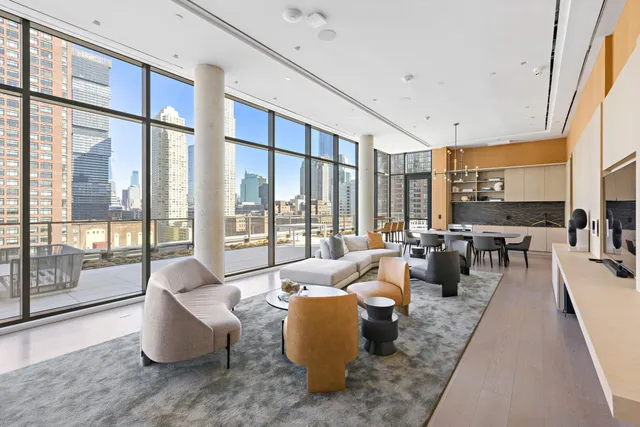 a living room with furniture and large windows
