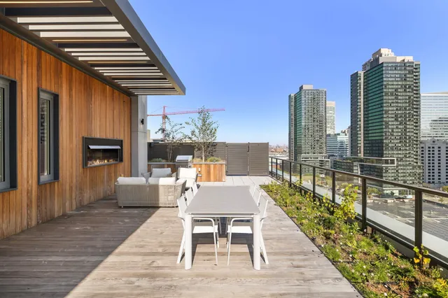 a patio with glass top table and chairs