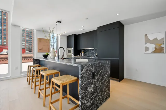 a dining room with furniture a large window and wooden floor