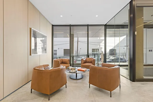 a living room with furniture and a floor to ceiling window