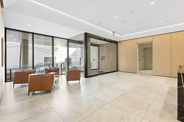 a living room with furniture and large windows