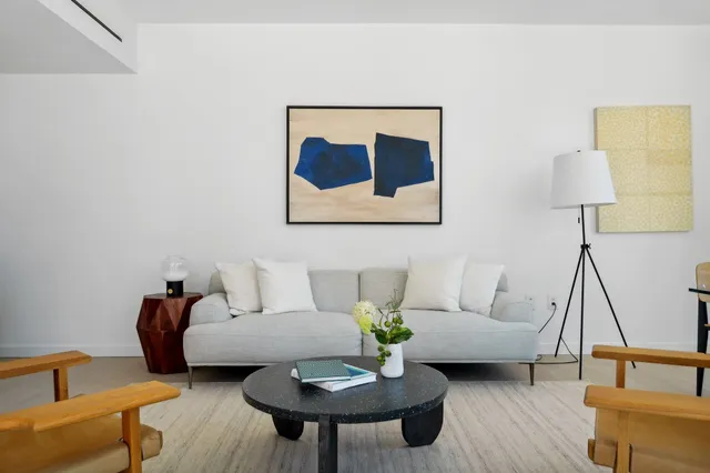 a living room with furniture and a lamp