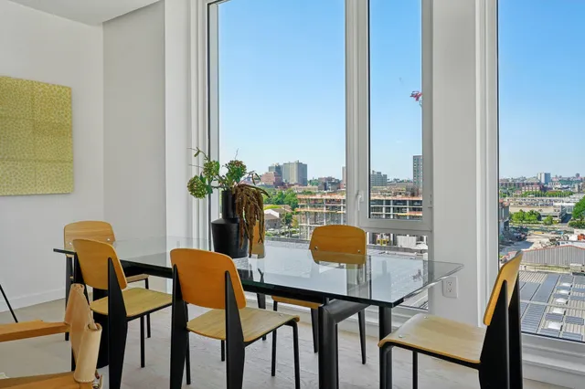 a view of a dining room with furniture and window
