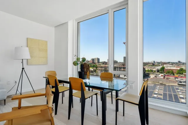 a view of a dining room with furniture and a window