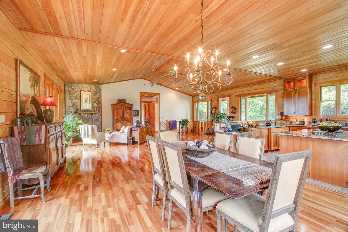 9626 Sherburne Farm Road Marshall, VA 20115 - Photo 21 of 57 a view of a dining room with furniture a kitchen and chandelier