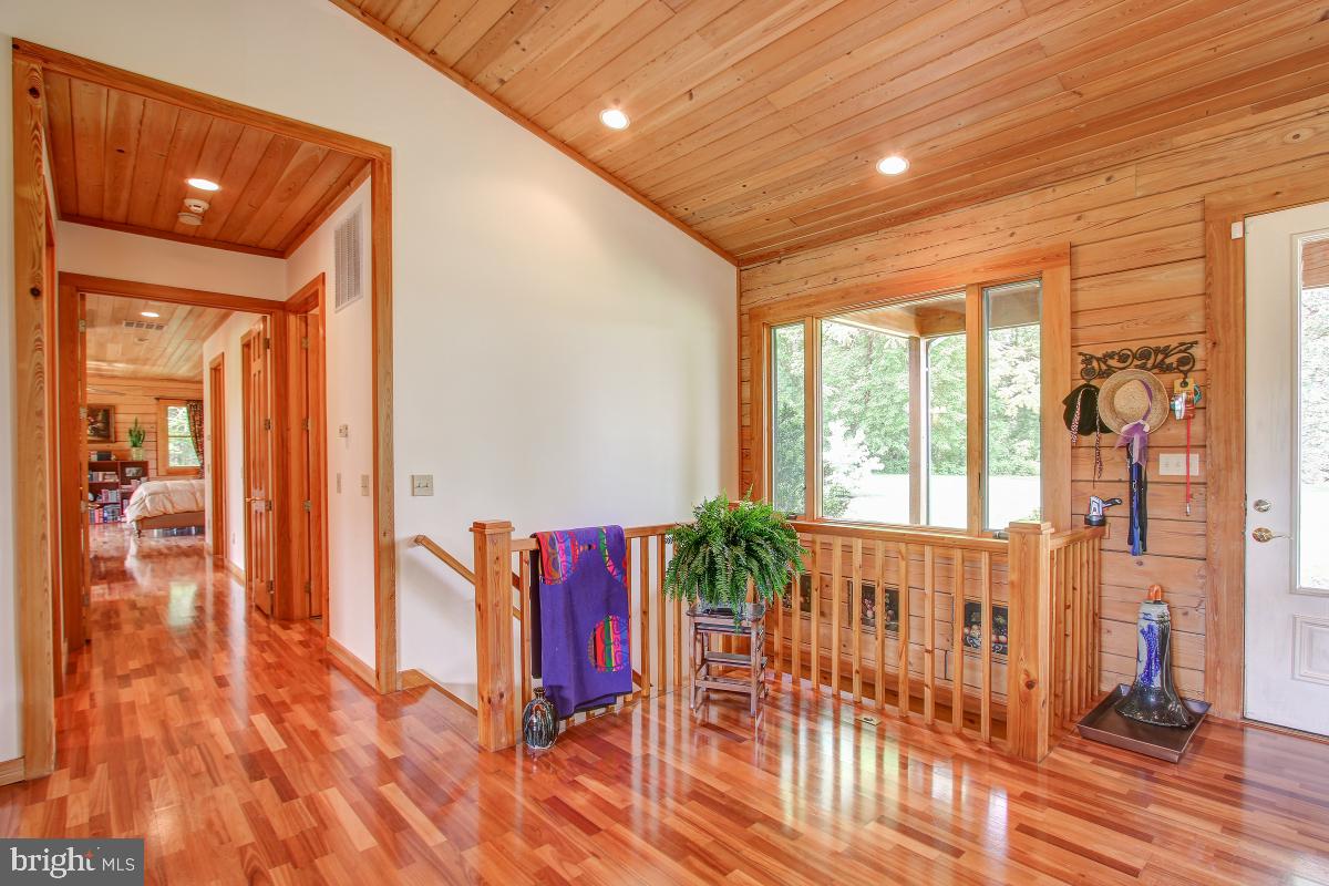 9626 Sherburne Farm Road Marshall, VA 20115 - Photo 32 of 57 a view of a hallway with wooden floor and windows