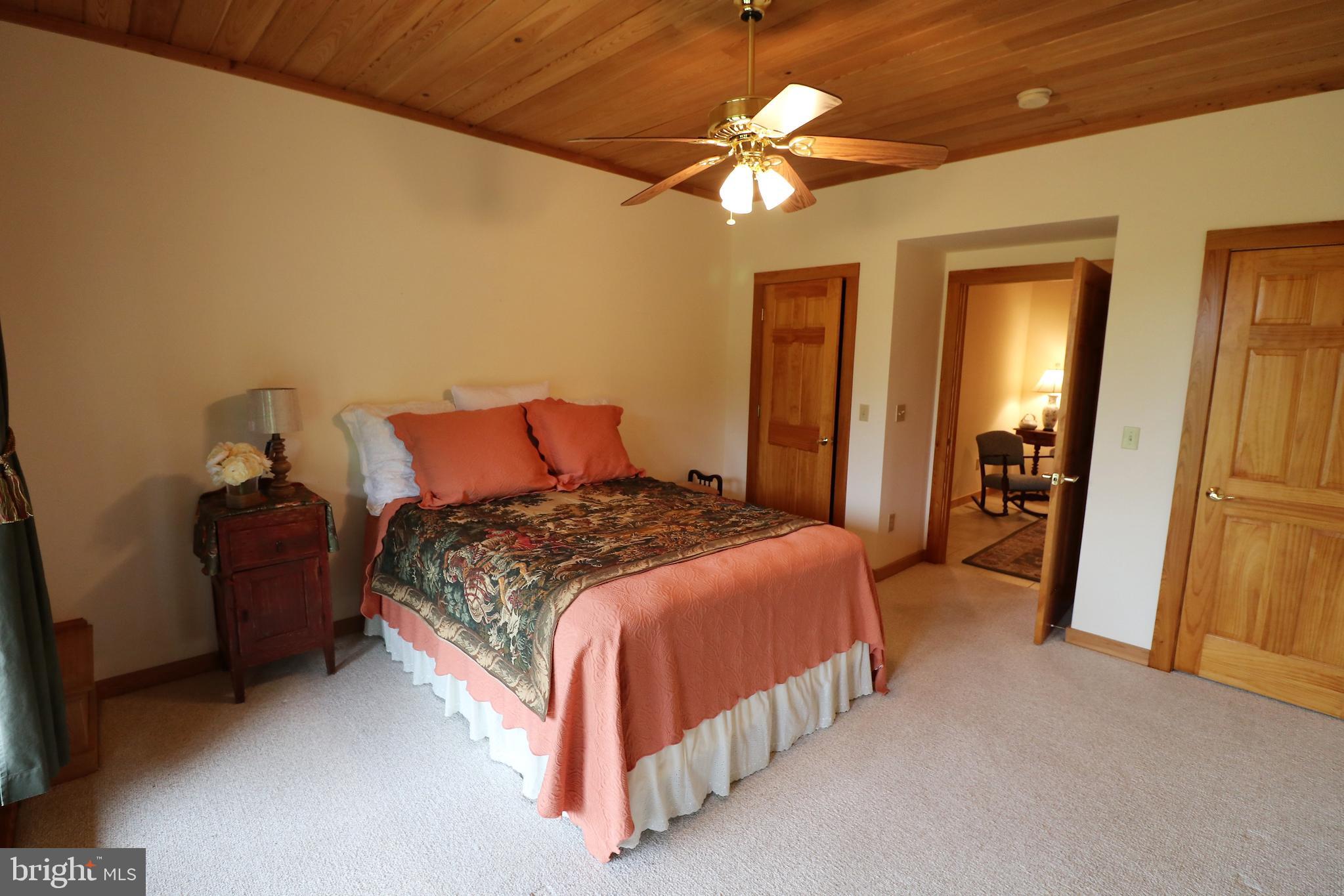 9626 Sherburne Farm Road Marshall, VA 20115 - Photo 35 of 57 a bedroom with a bed and a chandelier