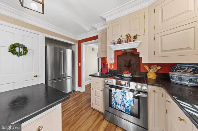 a kitchen with stainless steel appliances granite countertop a stove and a refrigerator