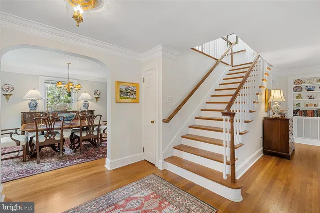 a view of entryway and hall with wooden floor