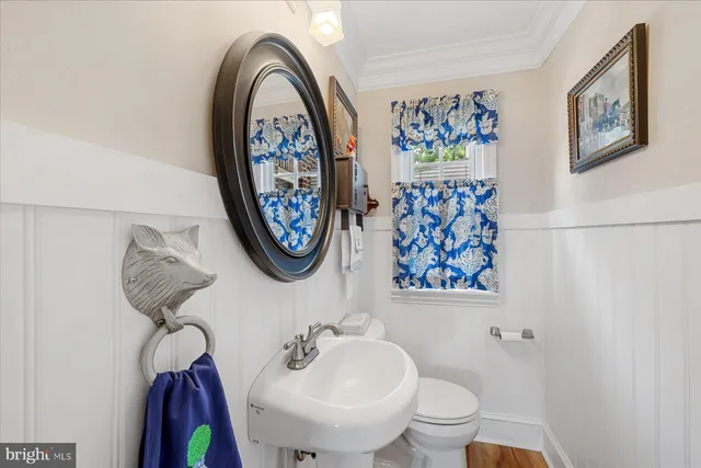 a spacious bedroom with a bed a dresser and a chandelier