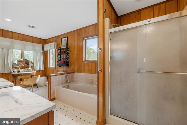 a bathroom with a sink toilet a mirror and shower