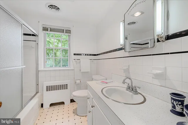 a bedroom with a bed a mirror and furniture