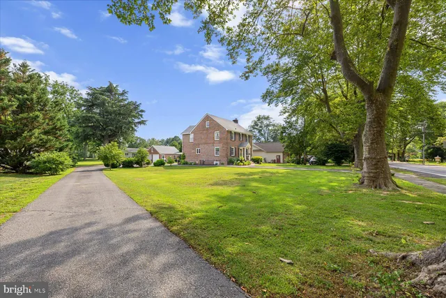 an aerial view of a house with a garden and lake view