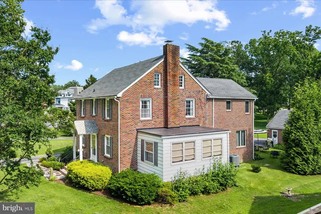 an aerial view of residential houses with outdoor space and river