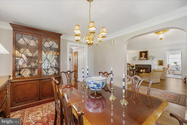 a view of a dining room with furniture a chandelier and wooden floor