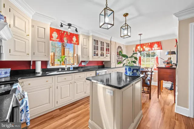 a kitchen with stainless steel appliances granite countertop a stove and cabinets