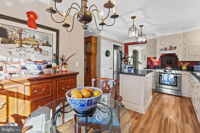 a kitchen with stainless steel appliances granite countertop a sink dishwasher and cabinets with wooden floor