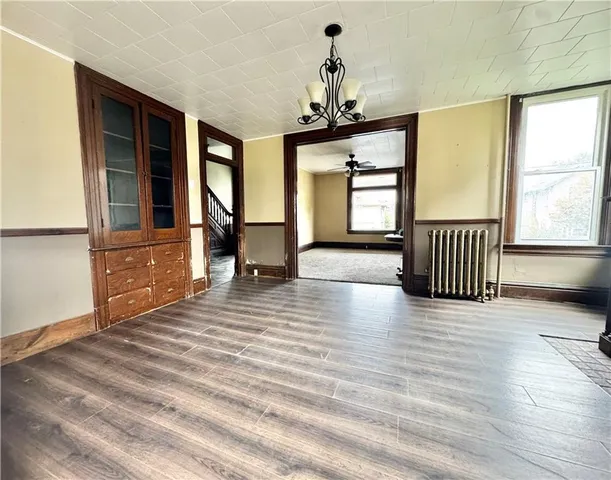 a view of a livingroom with furniture window and wooden floor