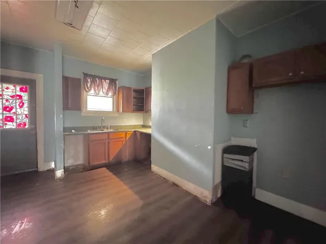 a bathroom with a sink a bathtub a mirror and a window