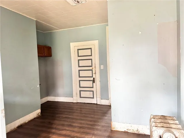 a view of room with window and wooden floor