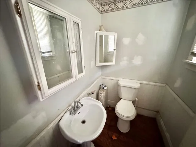 a bathroom with a toilet and a sink