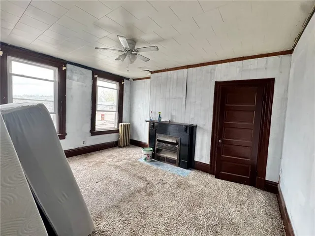 a view of a livingroom with furniture and a window