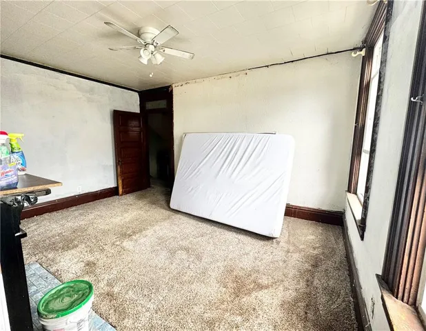 a view of room with window and ceiling fan