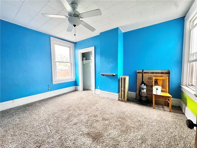 a bedroom with furniture and a window