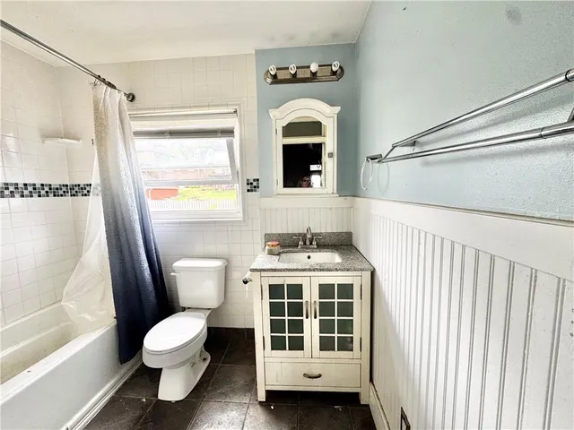 a bathroom with a toilet a sink and a bathtub