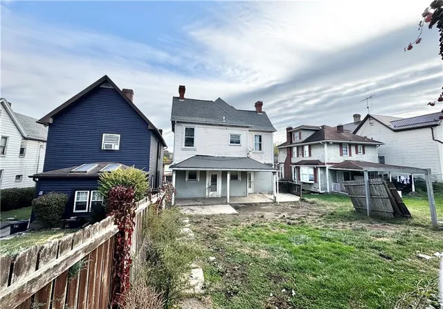 a front view of a residential apartment building with a yard
