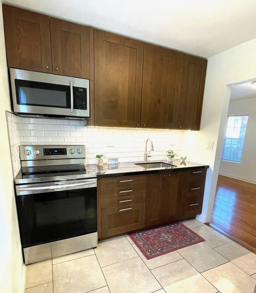 4334 Jefferson Street, Unit 1/2 Houston, TX 77023 - Photo 21 of 21 a kitchen with wooden cabinets and stainless steel appliances