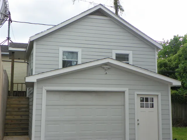 a view of house with garage