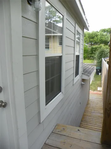 a view of a balcony with wooden floor and iron stairs