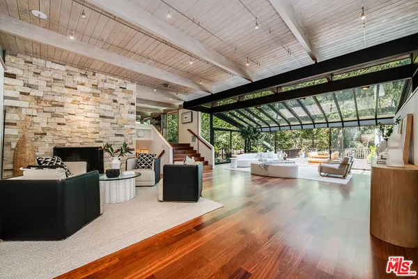 a living room with fireplace furniture and a flat screen tv