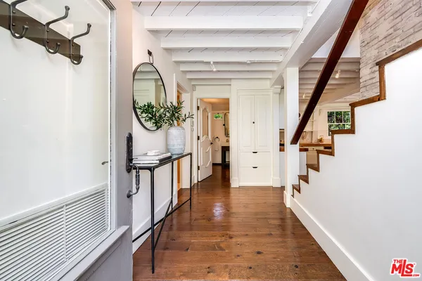 a kitchen with cabinets and wooden floor