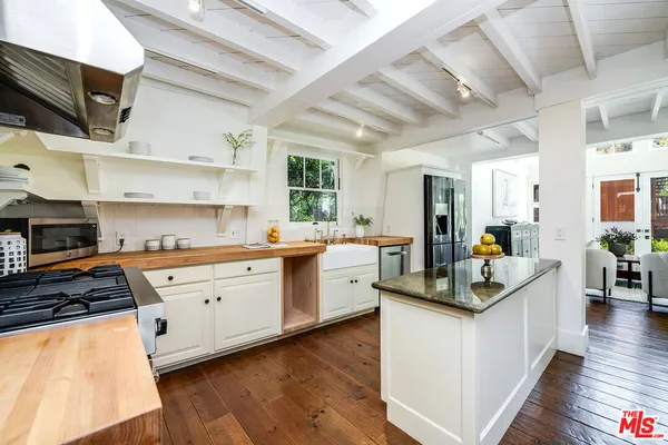 a living room with furniture and painting on the wall