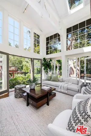 a view of a livingroom with furniture and a large window
