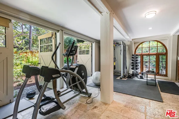 a living room with furniture a rug and a large window