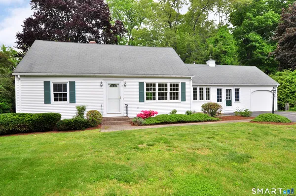 a view of a house with garden and yard
