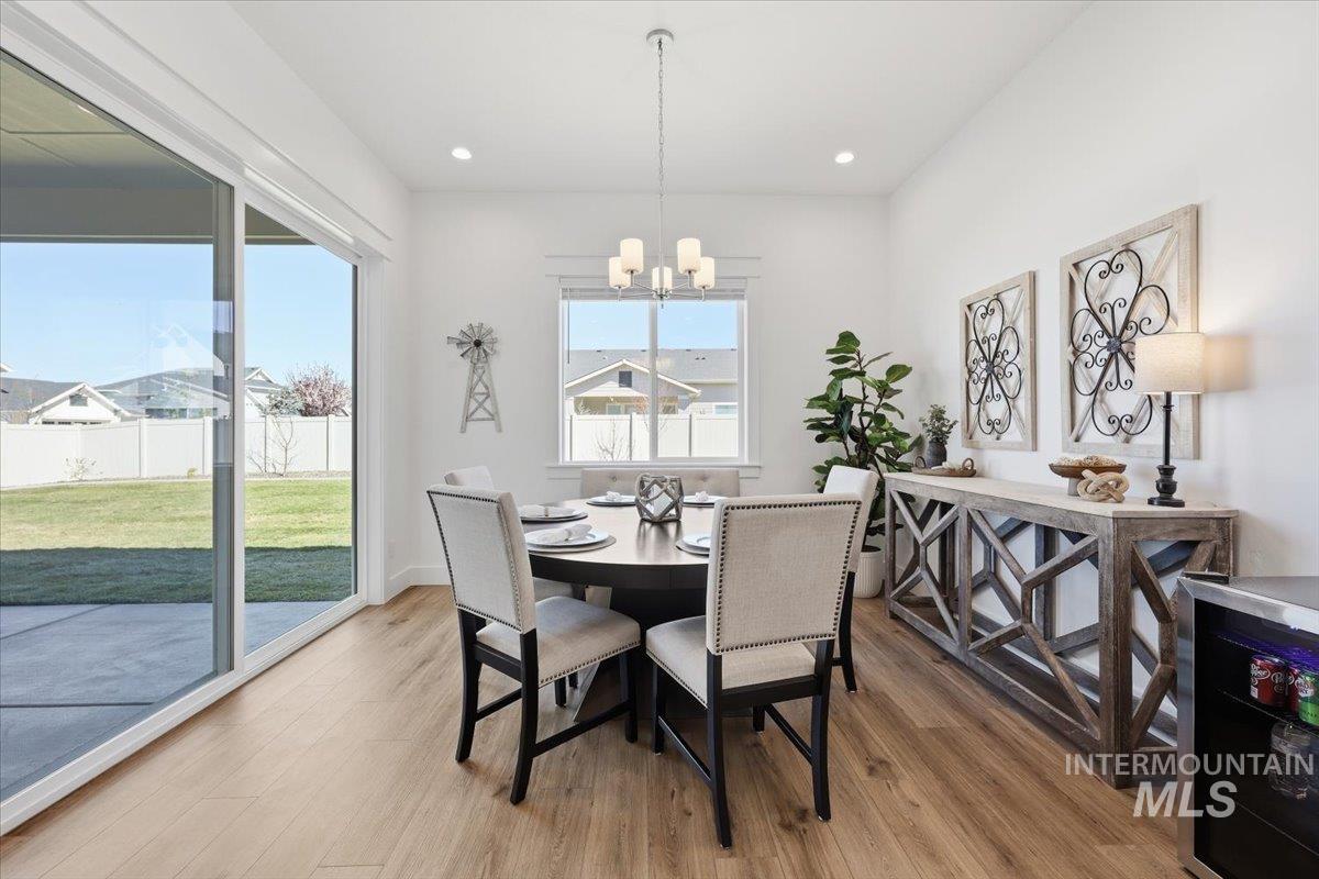 5512 North Ebony Way Meridian, ID 83646 - Photo 17 of 40 Dining area featuring a chandelier and light wood-type flooring