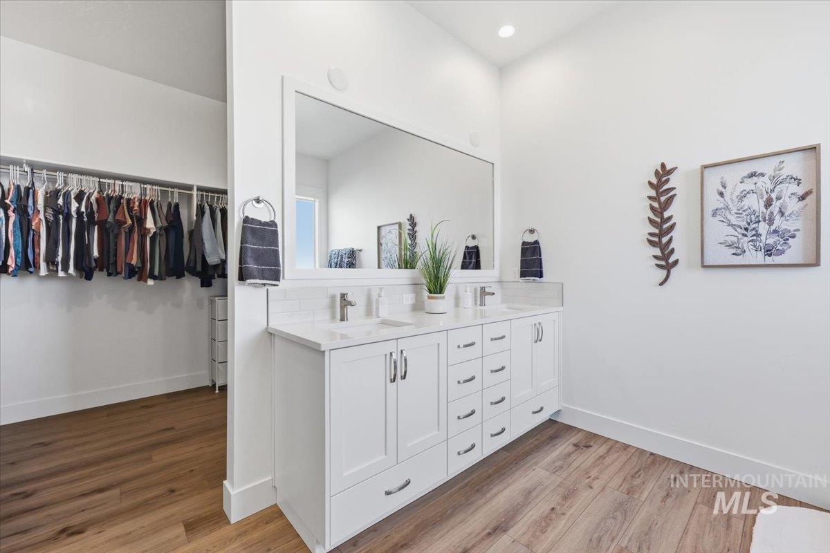 5512 North Ebony Way Meridian, ID 83646 - Photo 21 of 40 Bathroom with a spacious closet, double vanity, and light wood-type flooring