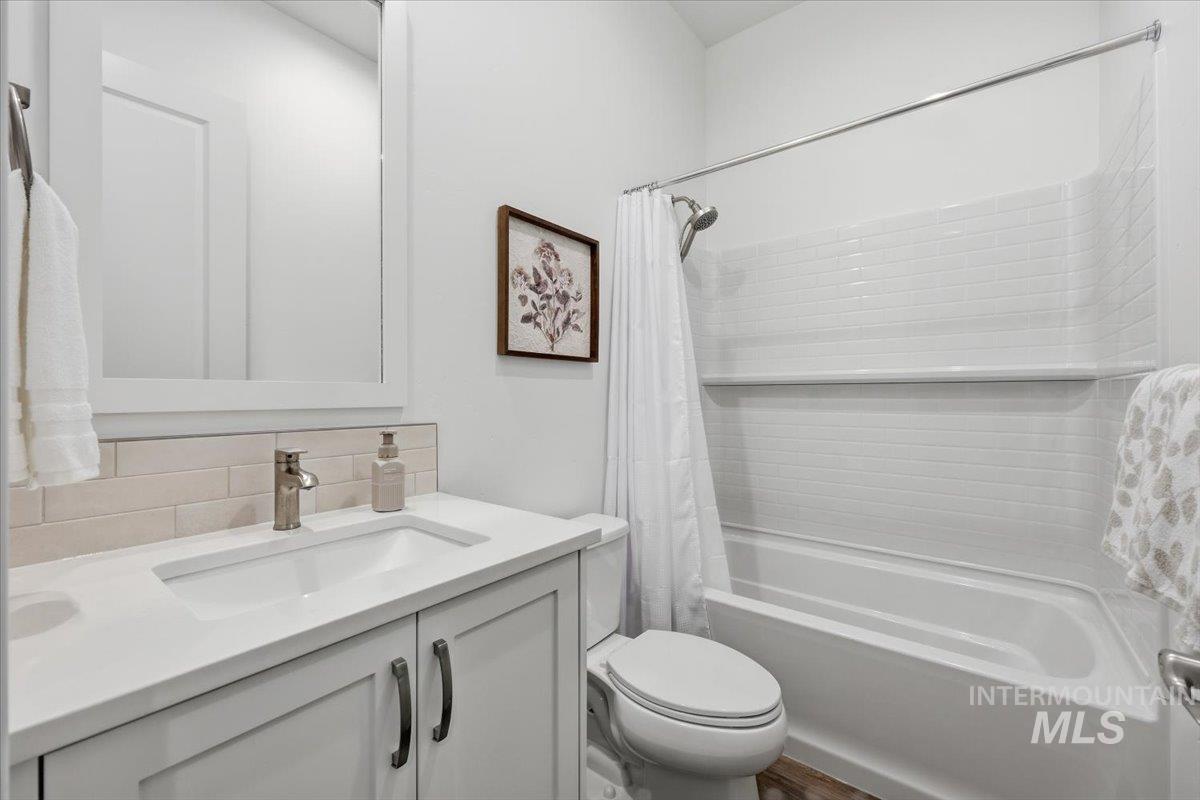 5512 North Ebony Way Meridian, ID 83646 - Photo 25 of 40 Bathroom featuring vanity, shower / bath combo, and backsplash