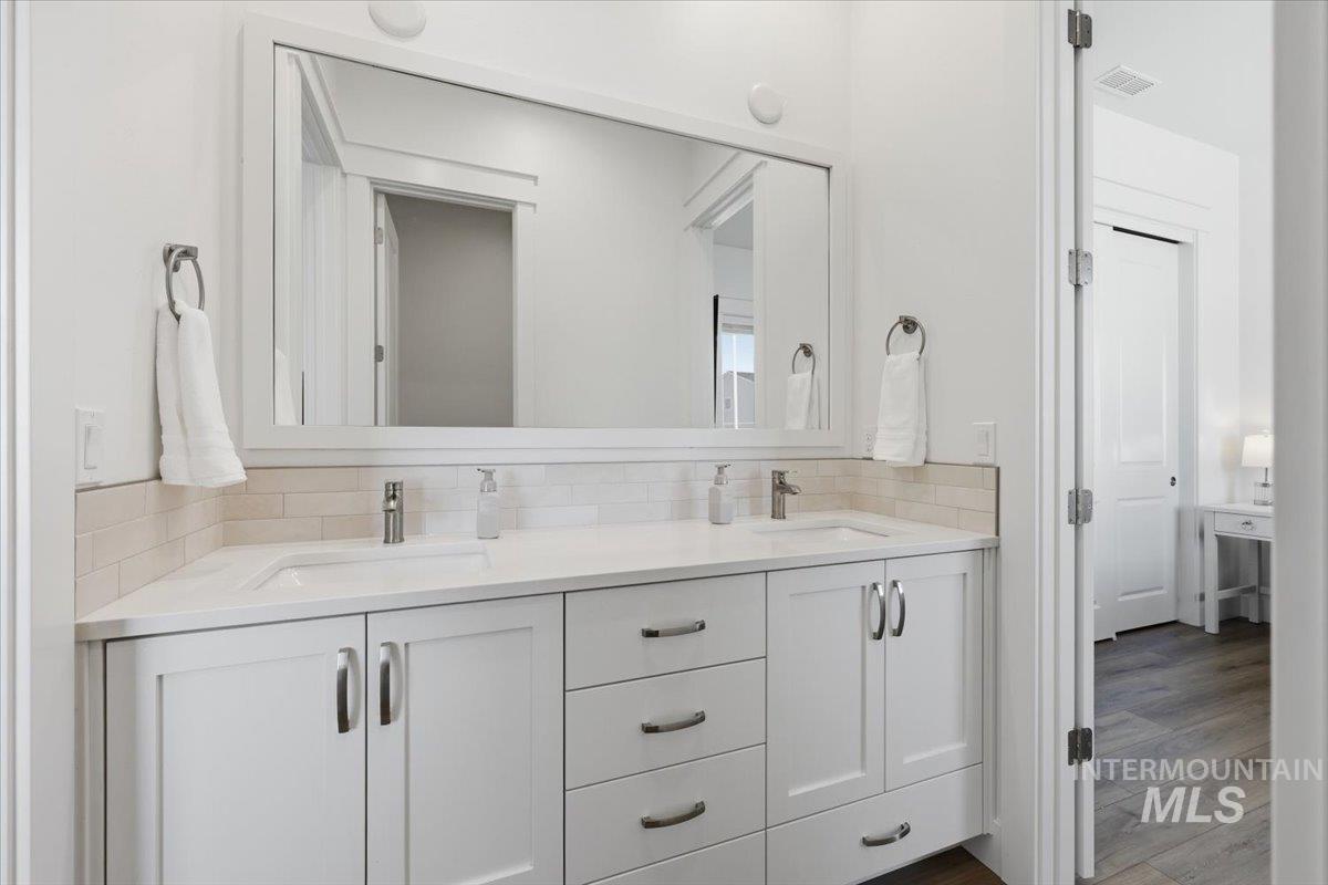 5512 North Ebony Way Meridian, ID 83646 - Photo 27 of 40 Bathroom with double vanity and wood finished floors
