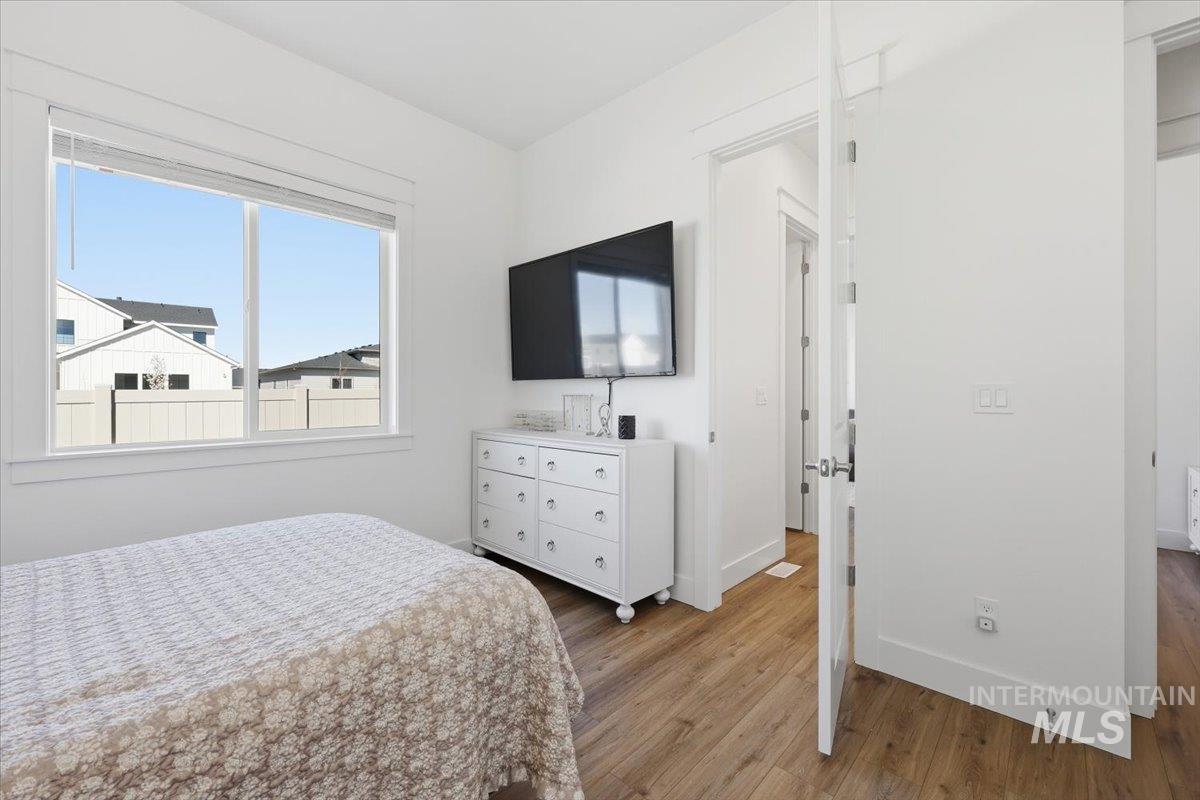 5512 North Ebony Way Meridian, ID 83646 - Photo 30 of 40 Bedroom with light wood finished floors and baseboards